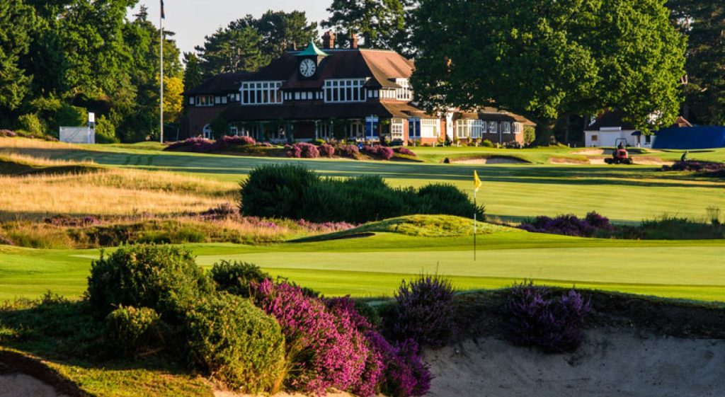 a building with a clock on the front of a golf course